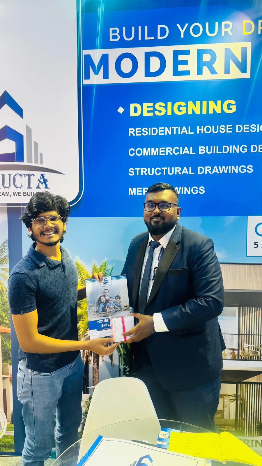 Structa director presenting a completed house design pack to a client
